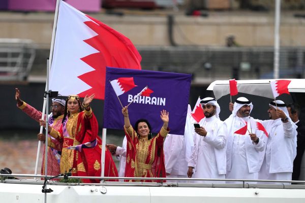 Paris 2024 Olympics - Opening Ceremony - Paris, France - July 26, 2024. Flagbearers Amani Alobaidli and Saud Ghali of Bahrain lead their contingent aboard a boat in the floating parade on the river Seine during the opening ceremony. REUTERS/Aleksandra Szmigiel